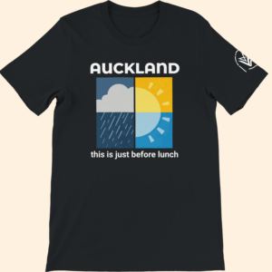 Black T-shirt with a square weather-style graphic and the text “Auckland this is just before lunch” on the front.