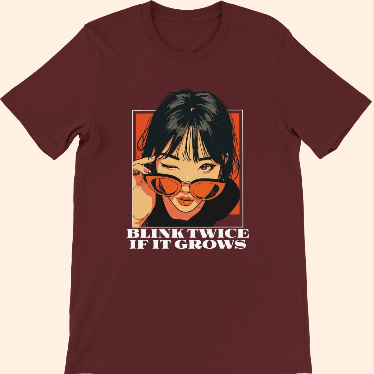 Heather maroon T-shirt featuring an illustrated woman wearing red sunglasses with the text Blink Twice If It Grows on the front