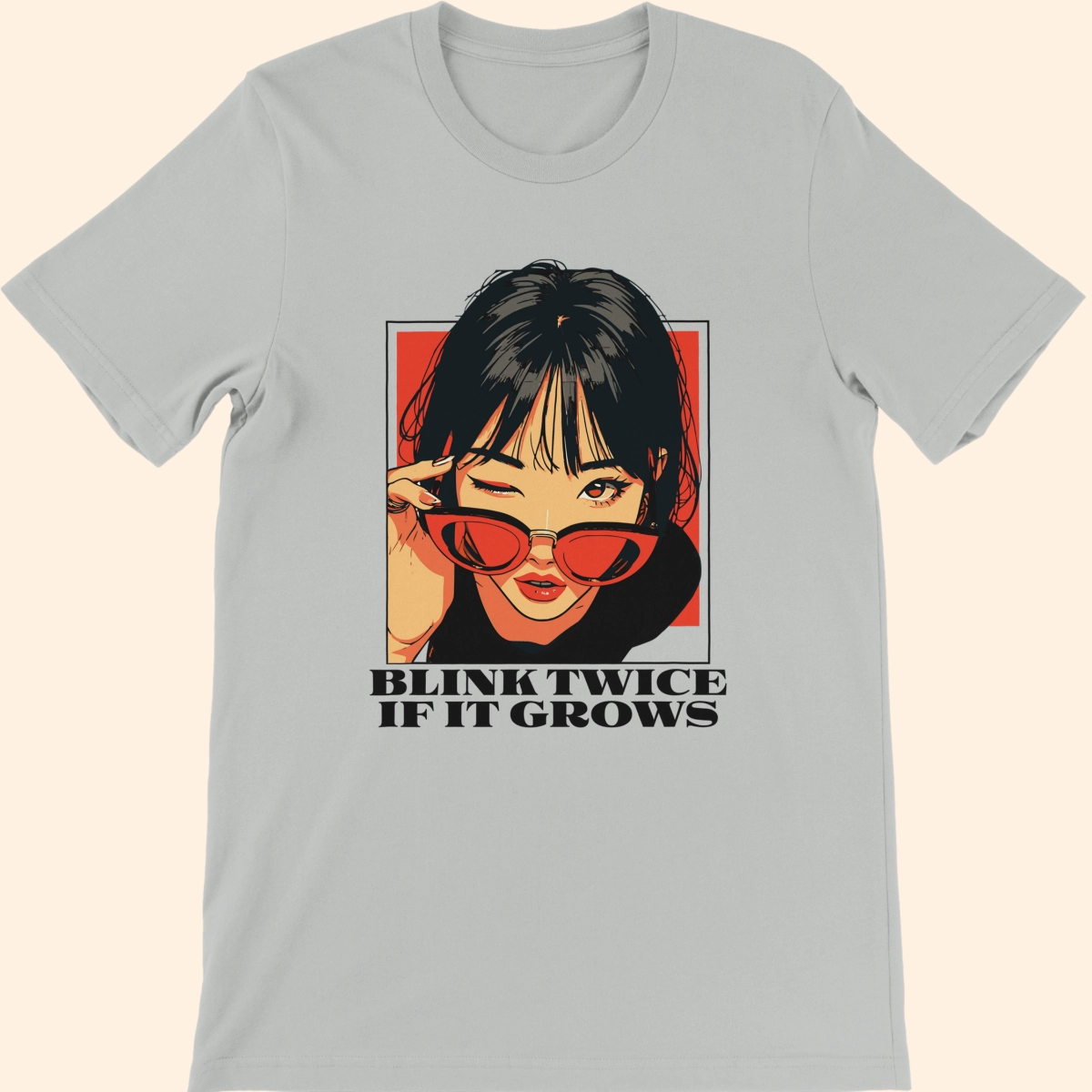 Silver T-shirt featuring an illustrated woman wearing red sunglasses with the text Blink Twice If It Grows on the front