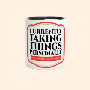 White ceramic mug with black interior featuring Currently Taking Things Personally Till Further Notice text design on the front.