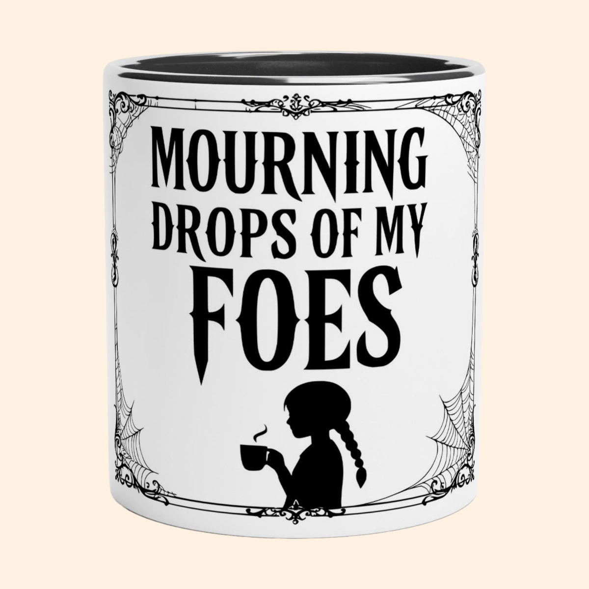 White ceramic mug with black interior featuring Mourning Drops of My Foes text, decorative border and a small figure holding a cup.