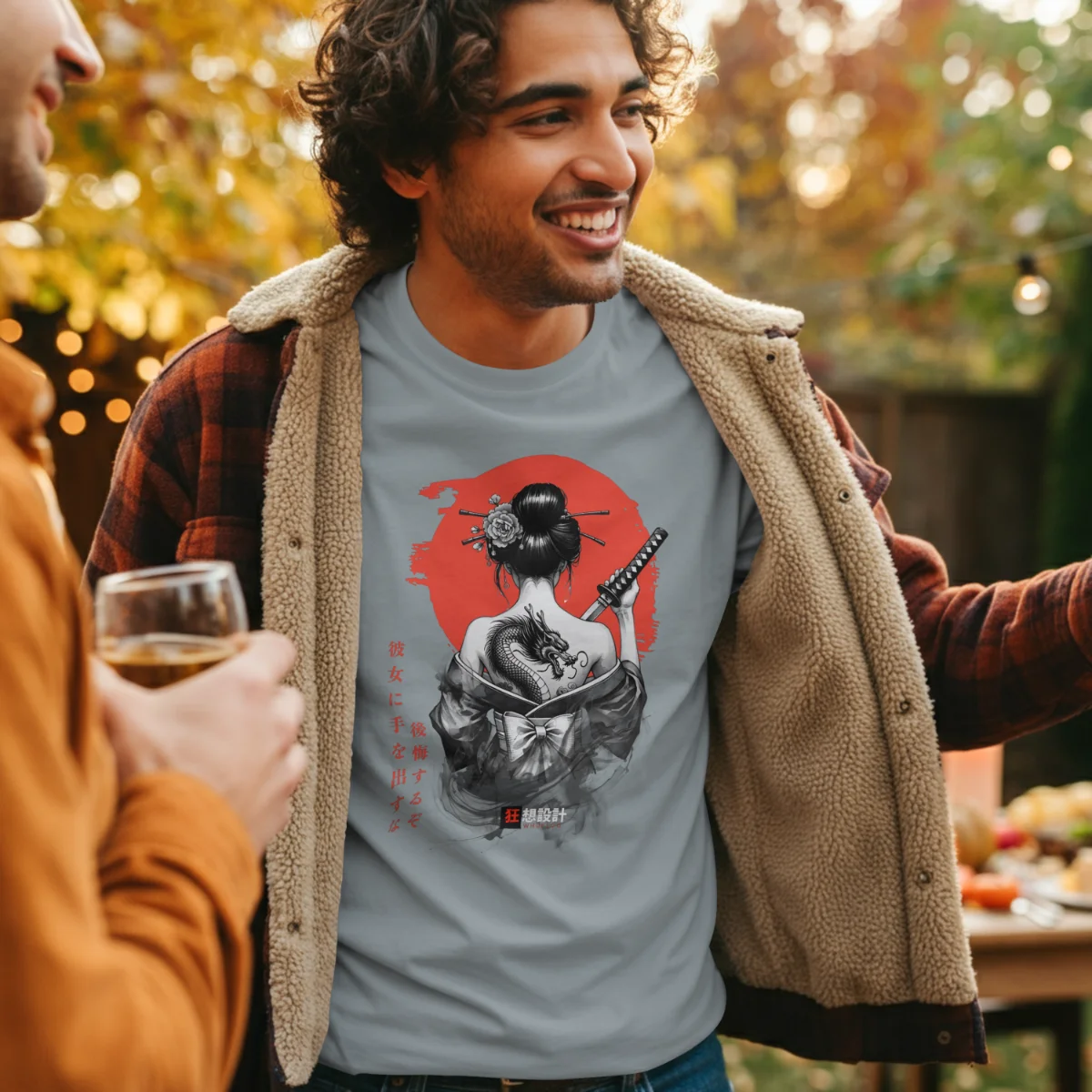 Model wearing an ash Onna-Bugeisha T-shirt with the front artwork visible in an outdoor setting.