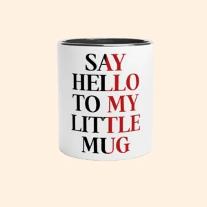 White ceramic mug with black interior featuring Say Hello To My Little Mug text design on the front.