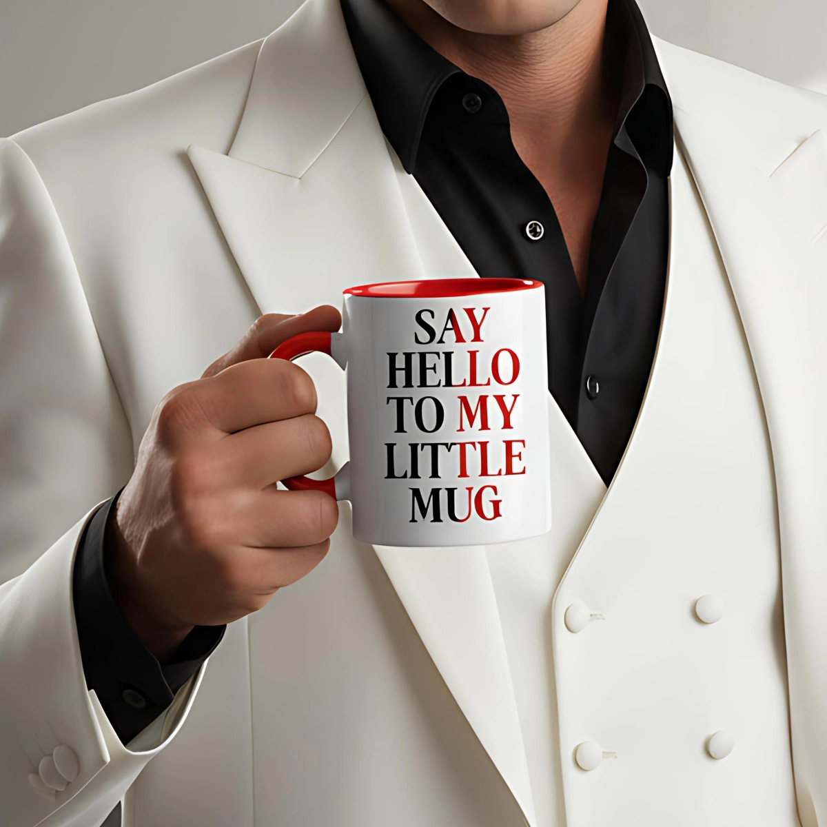 Person in white suit holding white ceramic mug with red interior and red handle featuring Say Hello To My Little Mug text design.
