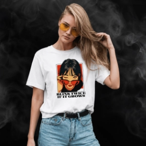 Model wearing a white Blink Twice If It Grows graphic T-shirt.